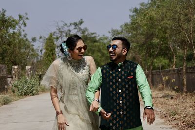 Young couple standing against plants