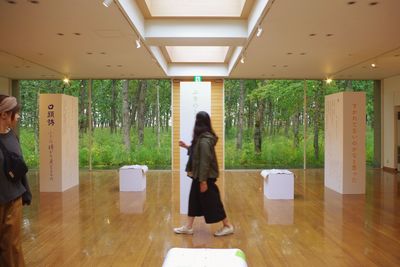 Rear view of woman standing in corridor