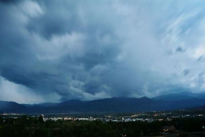 Scenic view of mountains against cloudy sky