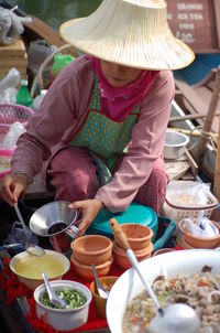 Front view of vendor selling food in market