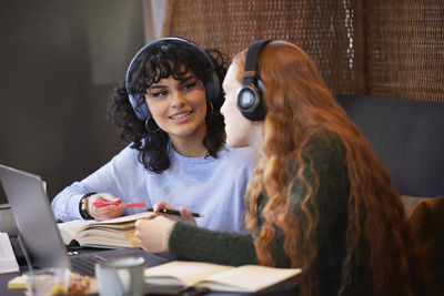 Female friends studying in cafe