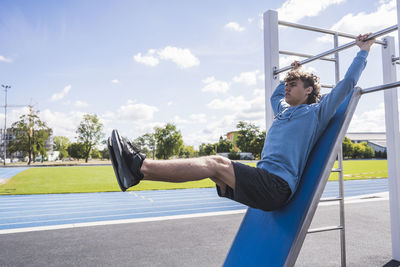 Young sportsman practicing on horizontal bar