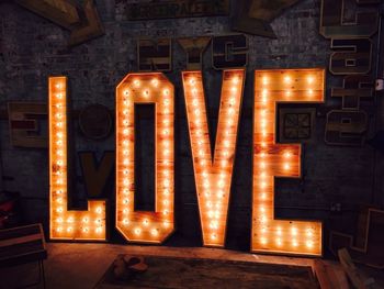 Illuminated love text on wall