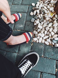 Low section of person standing on pebbles