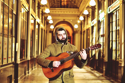 Full length of man playing guitar