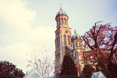 Low angle view of illuminated clock tower against sky