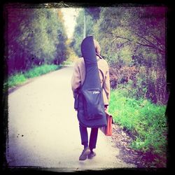 Woman walking on footpath