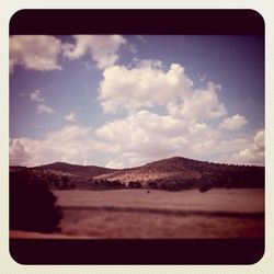 Scenic view of landscape against cloudy sky