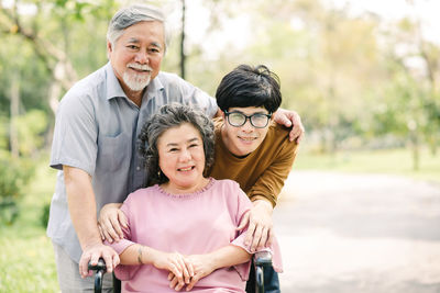 Portrait of parents with son in park