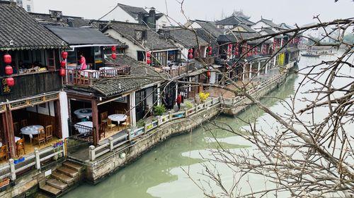Bridge over river amidst buildings