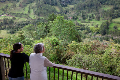 Senior mother and adult daughter traveling at the  view point over the cocora valley at salento