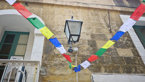 Low angle view of multi colored flags hanging on wall