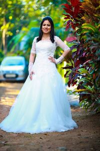 Happy woman with arms outstretched standing outdoors