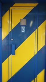 Close-up of yellow sign on building