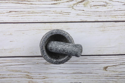 Directly above view of mortar and pestle on white wooden table