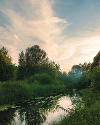 Scenic view of lake against sky at sunset