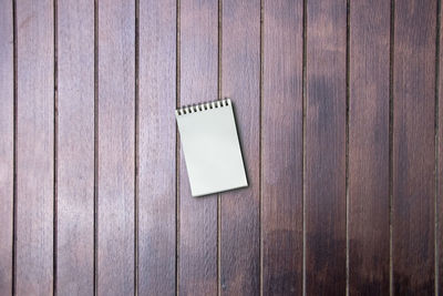 Directly above shot of note pad on wooden table