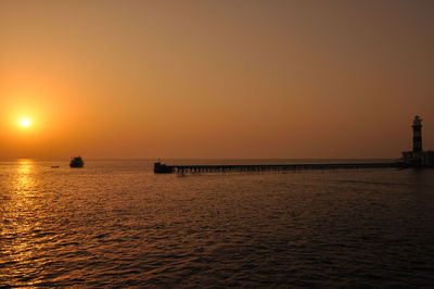 Scenic view of sea against clear sky during sunset