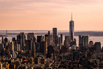 Aerial view of buildings against sky during sunset