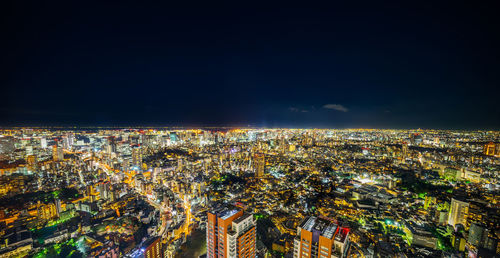High angle view of illuminated city buildings at night