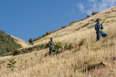 Men walking on field