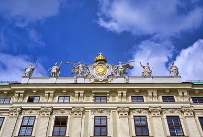 Low angle view of building against cloudy sky