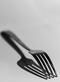 Close-up of piano on table against white background