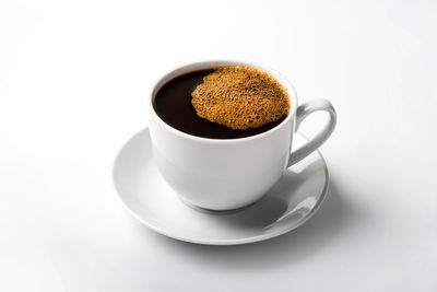 Close-up of coffee cup on white background