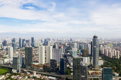 High angle view of modern buildings in city against sky