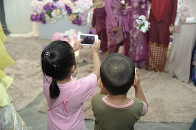 Rear view of woman photographing