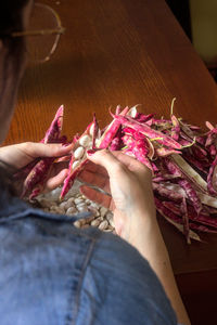 High angle view of woman hand holding pink roses