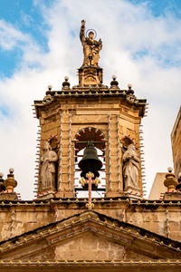 Low angle view of statue against cloudy sky