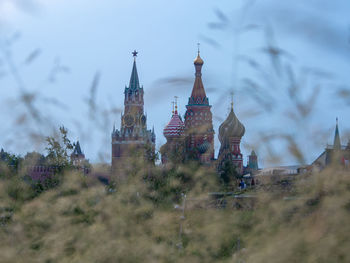 Panoramic view of buildings and trees against sky