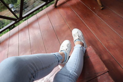 Low section of woman on wooden floor