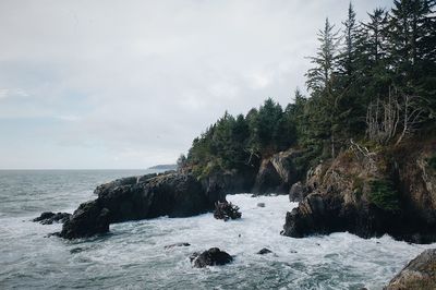 Scenic view of rocks and sea against sky