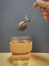 Cropped image of person making tea