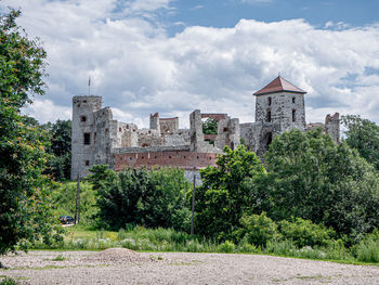 Buildings against cloudy sky