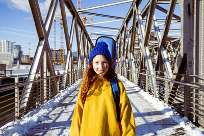 Portrait of woman standing in snow