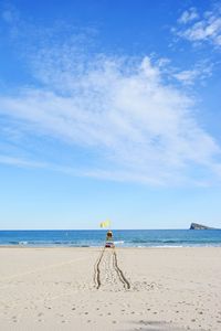 Scenic view of beach against blue sky