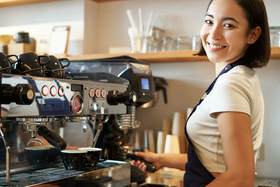 Portrait of young woman holding coffee