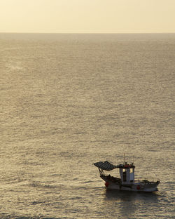 Ship sailing on sea against sky