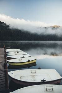 Wooden pier and boats on the wilderness lake .wonderful idyllic landscape with misty sunrise. 