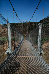 Boy standing on suspension bridge in drumheller, alberta