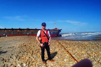 Full length of man standing on beach