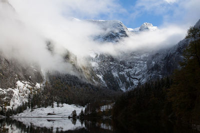 Scenic view of lake against mountains during winter