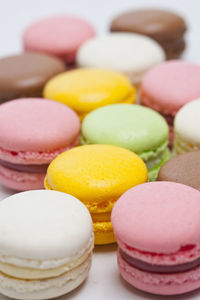 Close up of colourful macaroons on white background