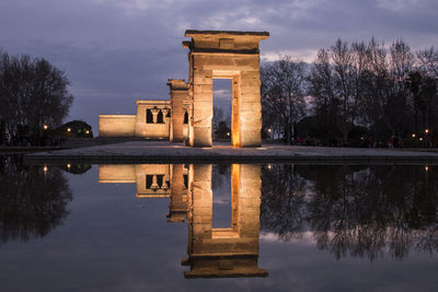 Reflection of building in lake at dusk. debod temple