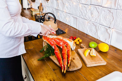 High angle view of man standing on cutting board