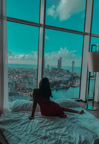Woman looking at view from window