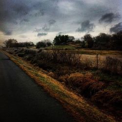 Empty road along countryside landscape